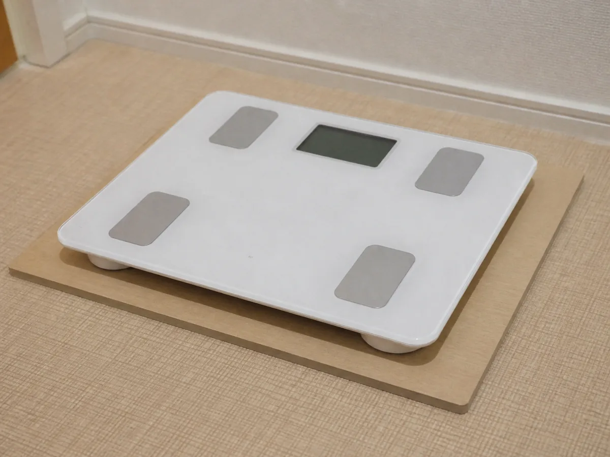 柔らかい床の上で敷板に置いた体重計